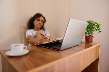 Woman Working Remotely in a Cozy Home Office Setting with Laptop