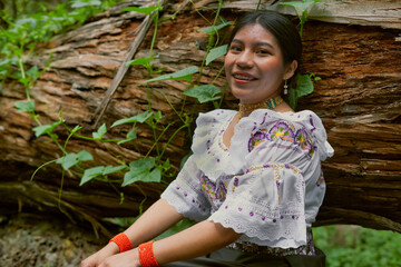 Smiling indigenous woman wearing traditional clothing in a lush forest