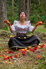 Indigenous woman meditating with rose petals in nature