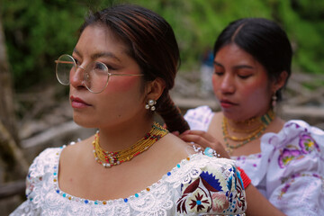 Indigenous women wearing traditional clothes and jewelry in otavalo