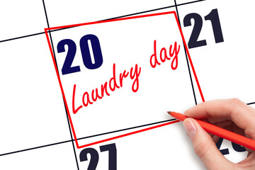 20th day of the month.  Hand writing Laundry day reminder and drawing red frame on calendar with...