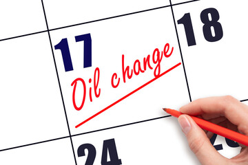 17th day of the month.  Hand writing Oil change reminder and drawing a line on calendar with red...