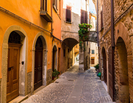 Fototapeta Old European cobblestone street with colorful buildings, warm afternoon light, high detail
