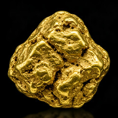 Photo of Golden Gold Nugget Isolated on Black Background
