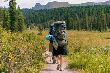 russia, ergaki - 4 august 2025 backpacker on the path in the mountain