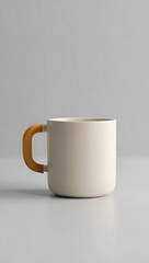 Obraz premium Minimalist Ceramic Mug with Wooden Handle on Neutral Background Ideal for Coffee or Tea Product Mockups and Lifestyle Photography Sessions