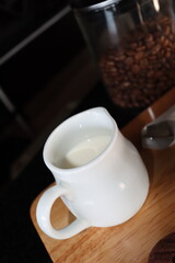 milk in the whit cup condiment for coffee topping