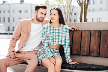 Beautiful fashion woman and her handsome elegant boyfriend in beige suit. Sexy brunette model in...