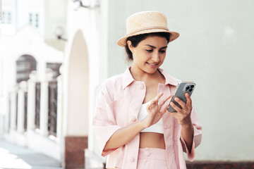 Young beautiful smiling hipster woman in trendy summer pink costume clothes. Carefree female posing...