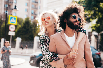 Beautiful fashion woman and her handsome elegant boyfriend in beige suit. Sexy blond model in...