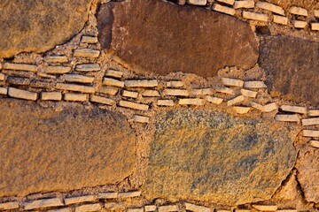 Closeup of a wall showing how at the Salmon Pueblo, New Mexico, they place tine stones between the...