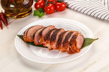 Sliced duck breast baked with cherry