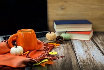 A Cozy Autumn Scene Featuring a Mug, Books, and Various Decorative Elements All Around