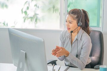 Remote Work. Professional woman in headset engaging in virtual communication at home office.