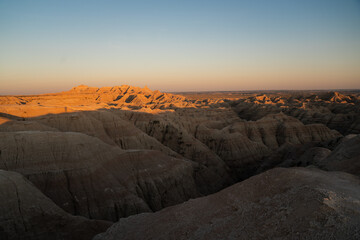Badlands rock formations at sunset