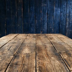 A high-resolution photograph showcases a rustic, weathered wooden table against a backdrop of dark blue painted wooden planks; perfect for product placement or background use.