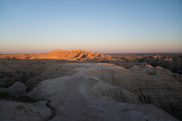Badlands rock formations at sunset