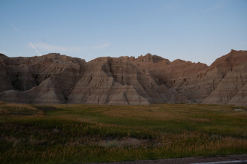 Sharp peaks and rounded hills in Badlands during dusk