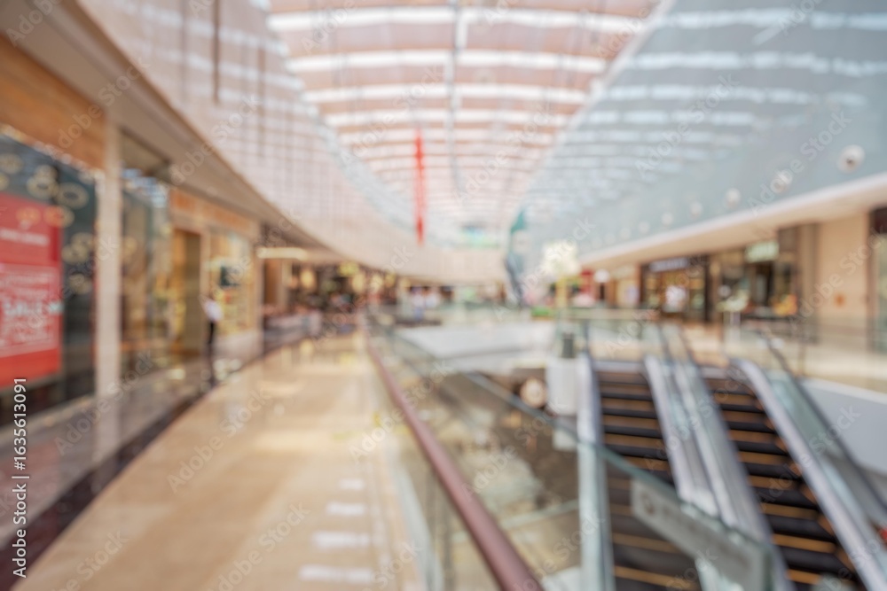 Aufkleber a blurred view of a shopping mall with an escalator in the foreground. the background is filled with