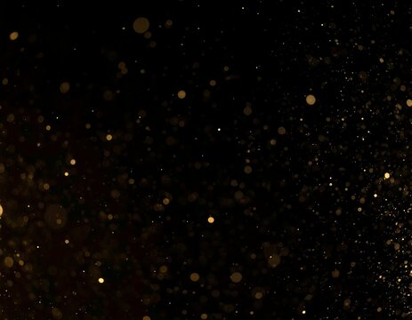 Golden particles swirling on black background