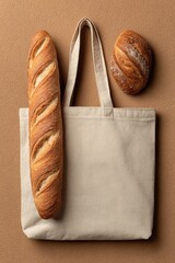 Beige canvas tote bag with a long loaf of bread and a round bread roll