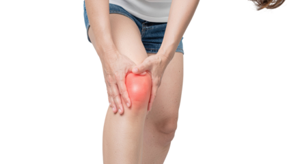 Young girl holding her painful knee in discomfort isolated on white background