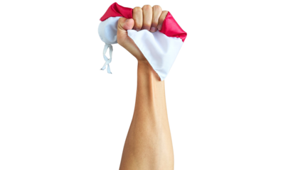 Photo of a hand firmly gripping the red and white Indonesian flag on a transparent background, showcasing fabric texture and bold colors as a symbol of national pride and patriotism.