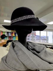 Black female mannequin wearing hat on shelf in store, display retail. Close-up.