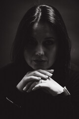 Portrait of a woman with dark hair, done in low key style.