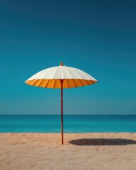 Beach umbrella on sand, azure sea, clear sky