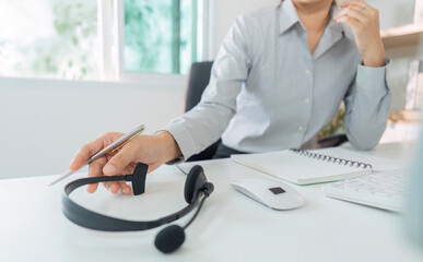 Remote Work. Professional woman using headset for virtual communication in modern office.
