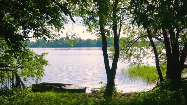 Video of a lonely boat drifting on the calm Volga River near Uglich, Russia, surrounded by stunning Russian nature in Yaroslavl region.
