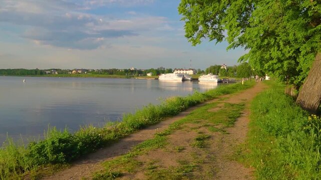 Video of a panoramic view of the Volga River in Uglich, Yaroslavl region, Russia, featuring cruising ferries on a bright summer day.
