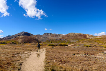 Fototapeta premium hiker in the mountains, A hiker captures the moment, Colorado’s Independence Pass framed by endless mountains and a perfect sky.