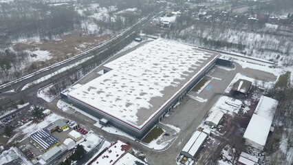 Top view logistics building with winter snow