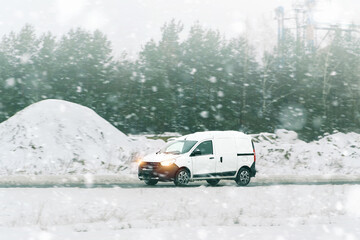 Freight van driving through snowy landscape © AlexGo