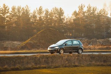 Hatchback vehicle enjoying rural landscape drive