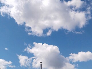 smoke from the chimneyCumulus clouds white fluffy blue sky landscape air sunny day