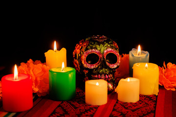 Day of the Dead celebration altar with skull, magnolia blossoms and wax candles