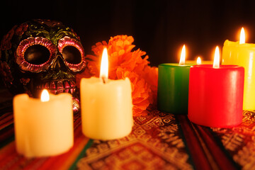 Altar with metallic-decorated skulls, candles and traditional magnolias