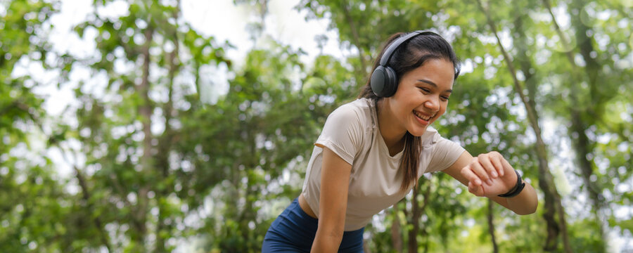 Asian woman jogging in the morning for good health, self care, enjoy running to catch time, healthy exercise concept, fitness and healthy lifestyle. Copy space.