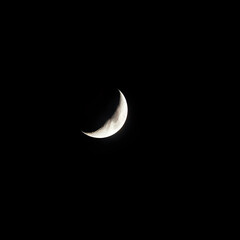 Naklejka premium the crescent/ half moon seen in the nightsky/ in space