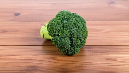 Fresh broccoli head on wooden table