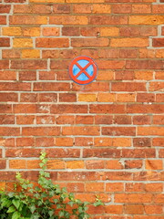 No Parking and Stopping Sign on Old Brick Wall. Historic brick wall with no parking and stopping...