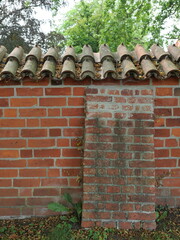 Brick Wall with Buttress and Coping Tiles. Brick wall with buttress and monk-nun coping. Stable,...