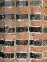 Historic wall corner in Ratzeburg Cathedral with round, black-glazed molded bricks in every other...