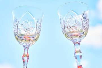 Couple.Drinking festive wine.Two shining crystal wine glasses on sky