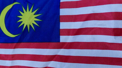 Waving Malaysian Flag on a Cloudy Day