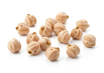 Group of fresh chickpea seeds with a light brown hue on a white surface