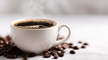 Steaming hot black coffee in white cup with roasted coffee beans on light background.